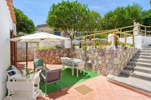 a patio with a table and chairs and an umbrella at Casa Gio & Angie in Forio d'Ischia