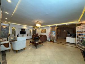 a large living room with couches and a table at Aziz Egypt Hotel in Cairo +146 photos