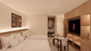 a living room with a white bed and a table at Hotel Inspiroom Jongro in Seoul