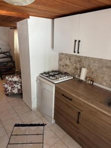 a kitchen with a stove and a counter top at Melisa Garden in Cunda