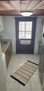 a kitchen with a door and a tile floor at Melisa Garden in Cunda +21 photos