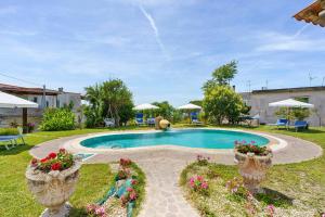 a swimming pool in a yard with plants and flowers at Casa Gio & Angie in Forio d'Ischia