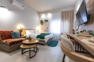 a living room with a bed and a couch at Breeze Apartments Megara - Echo in Megara