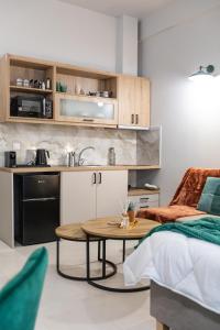 a room with a bed and a table and a kitchen at Breeze Apartments Megara - Echo in Megara +10 photos