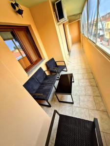 a room with two chairs and a table and a window at House Manu in Assemini