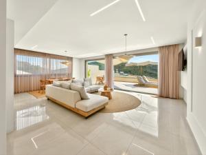 a living room with a couch and a table at Meliora Exclusive Villas Parga in Parga