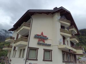 a building with a sign on the side of it at Haus Belstar B in Naters