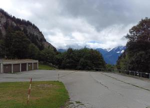 an empty parking lot with mountains in the background at Haus Belstar B in Naters