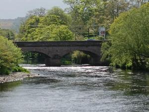 a bridge over a river with a car on it at Ballyvoy Camping Barn in Willenhall