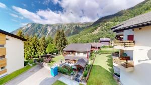 an aerial view of a house with mountains in the background at Haus Belstar B in Naters