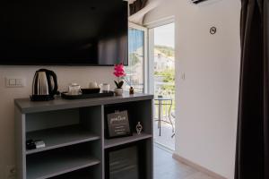 a kitchen with a counter top and a window at Matej's rooms in Korčula