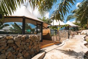 a resort with a stone wall and a pavilion at Seawind Cloudcrest Resort in Semporna