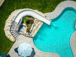 an aerial view of a water slide in a pool at Lopar Family Residence 543a in Lopar
