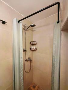 a bathroom with a shower with a shower curtain at La maison verte NAFPLIO in Nafplio +26 photos