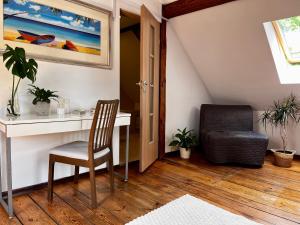 an attic room with a desk and a chair at Żuławski Dom in Nowy Dwór Gdański +41 photos