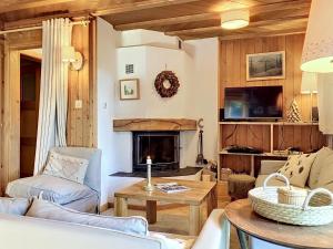 a living room with a couch and a fireplace at Chalet Mutzli by Interhome in Agettes