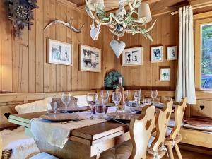 a dining room with a table and a chandelier at Chalet Mutzli by Interhome in Agettes