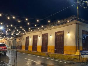 a row of houses with lights on a street at La Villa Study & Relax Apartment in Los Santos
