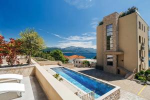 an image of a house with a swimming pool at Adriatica sea view apartment in Baošići