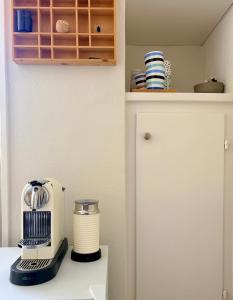 a kitchen counter with a blender on top of it at Villa Fleurettes STUDIO in Le Châble