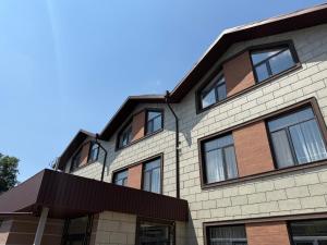 a building with windows on the side of it at AiTumar boutique hotel in Almaty