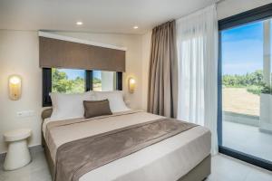 a bedroom with a large bed and a large window at Calista Horizon by Booking Kottas in Kallithea Halkidikis