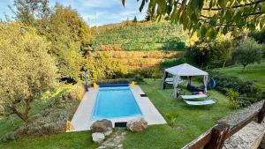 a swimming pool in a yard with a gazebo at MULINO VECCHIO in Minucciano