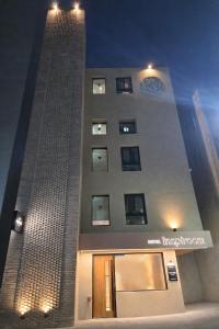 a tall building with a clock on the side of it at Hotel Inspiroom Jongro in Seoul