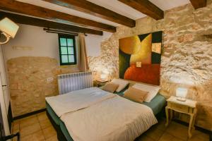 a bedroom with a bed and a painting on the wall at Font Neuve in Souillac +157 photos