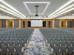 an empty banquet hall with chairs and a stage at Rixos Water World Aktau - Theme Park Free Access in Aktau +143 photos