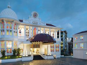 a large white building with a dome on it at Mövenpick Myth Hotel Patong Phuket in Patong Beach