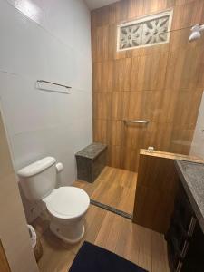 a bathroom with a white toilet and a shower at Casa do Bento - Lençóis Maranheses in Santo Amaro +26 photos