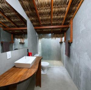 a bathroom with a sink and a toilet at ArpoadorBangalôparaísoperdido in Tutóia