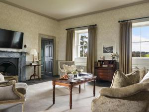 a living room filled with furniture and a fireplace at Carton House A Fairmont Managed hotel in Maynooth