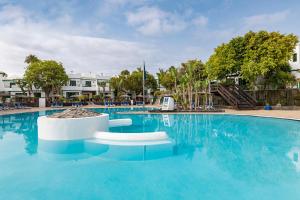 a large swimming pool with blue water at THB Royal in Playa Blanca