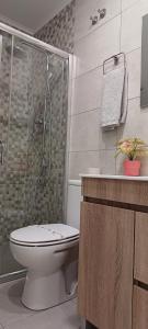 a bathroom with a toilet and a glass shower at Villa Ti Neves - Peniche Beach Residence in Peniche +46 photos