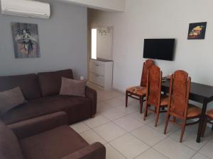 a living room with a couch and a table at Karya Apartments in Koycegiz