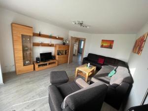 a living room with a couch and a table at Am Wangermeer 14 in Wangerland