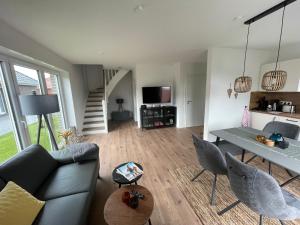 a living room with a couch and a table at Wangerbrise in Wangerland