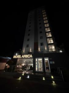 a building with a hotel atlas at night at Hotel Africa in Maputo
