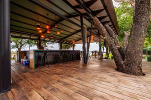 a pavilion with a tree on a wooden deck at Zambezi Mubala Lodge in Katima Mulilo +15 photos