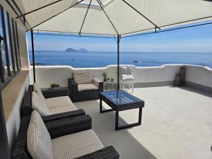 a balcony with chairs and a view of the ocean at Hotel Odissea in Canneto +33 photos