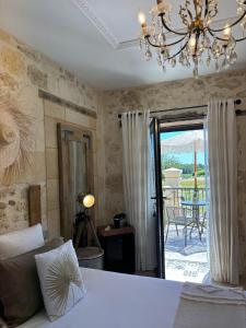 a bedroom with a bed and a chandelier at Le Relais de la Chouette in Berson