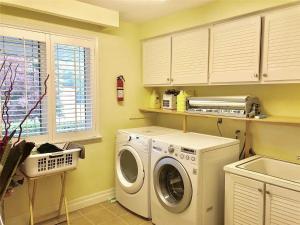 a laundry room with a washing machine and a sink at House in Markham in Markham