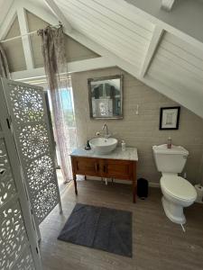 a bathroom with a sink and a toilet at Matopos Loft in Stilbaai-Wes