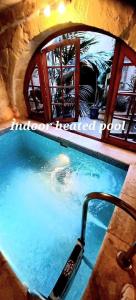 a swimming pool in a stone building with at Mithna farmhouse in Għarb