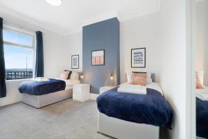 a bedroom with two beds and a window at Sunderland 3BR Retreat Sleeps 6 by Stay With Us in Pallion
