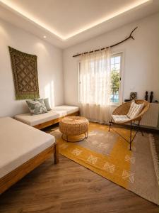 a living room with a couch and a chair at Kefia house in Hammamet Nord +8 photos