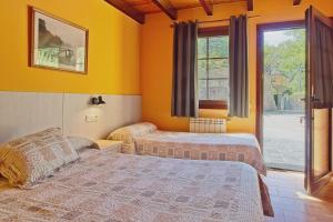 a bedroom with two beds and a window at Ribera del Cantero in Ponferrada +33 photos