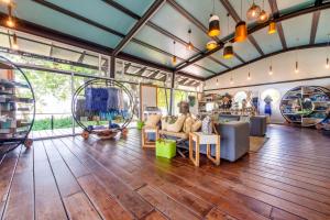 a large living room with wood floors and glass walls at Zambezi Mubala Lodge in Katima Mulilo